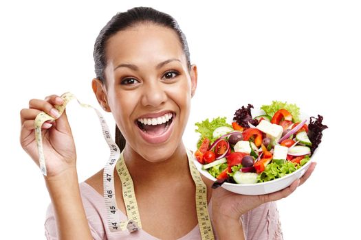 Seeing the results. Portrait of an attractive young woman holding a measuring tape and a bowl of salad.