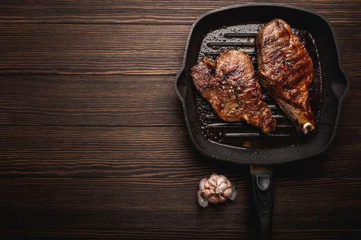 Fried meat steaks in pan