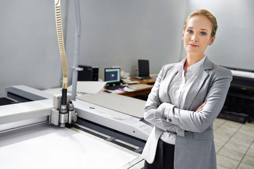 If its printable, we can do it. A self-assured young publisher standing alongside a printing machine.