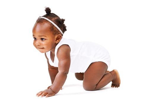 Time for an adventure. Studio shot of a baby girl crawling against a white background.
