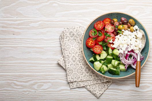 Greek salad with vegetables and feta cheese from above copy space