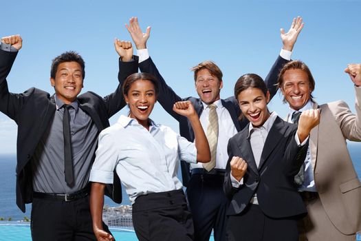 Were number one. a group of business people acting excited with their hands in the air.