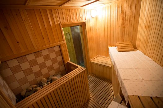 Interior of a wooden sauna with sun lounger