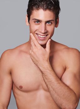 Now thats smooth. Studio shot of a handsome bare chested young man grooming.