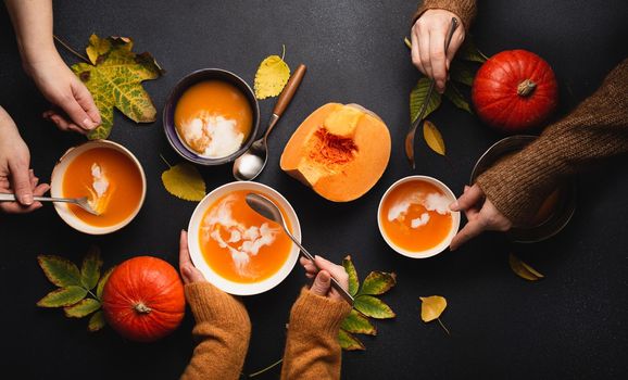 Top view people eating autumn pumpkin soup