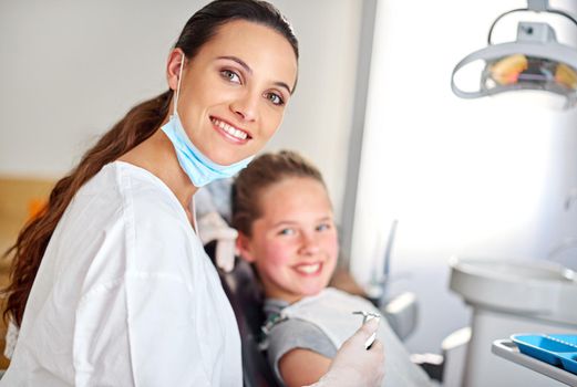Your friendly dentist. a female dentist and her child patient.