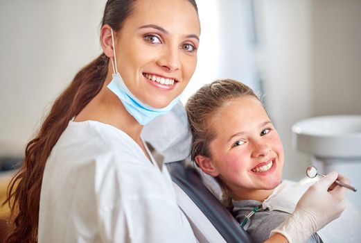 Shes gentle with the young ones. Portrait of an attractive female dentist and her child patient.