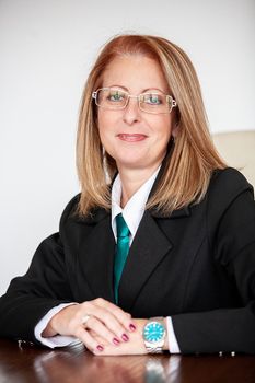 Portrait of businesswoman in her 40s at the office smiling at the camera