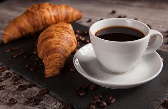 Breakfast with fresh croissants and cup of coffee