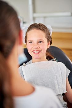 At ease in the dentists chair. a young girl at the dentist.