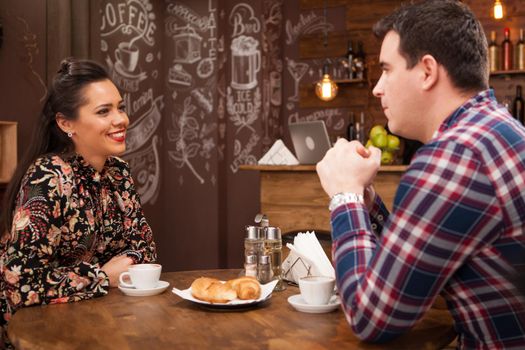 Happy couple drinking coffee in vintage coffee shop