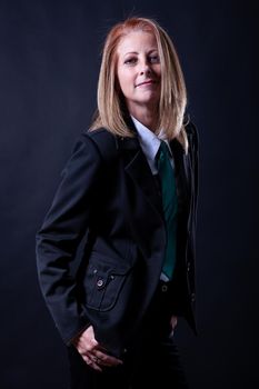 Blonde woman in business suit on blackground