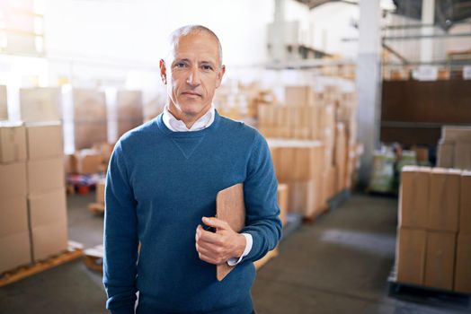 If you make it, well ship it. Portrait of a mature man standing on the floor of a warehouse.