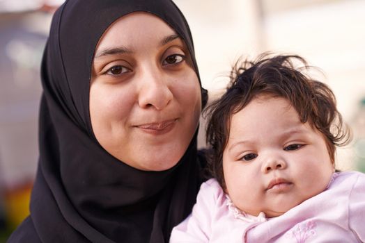 She takes after her dad. a muslim mother and her little baby girl.