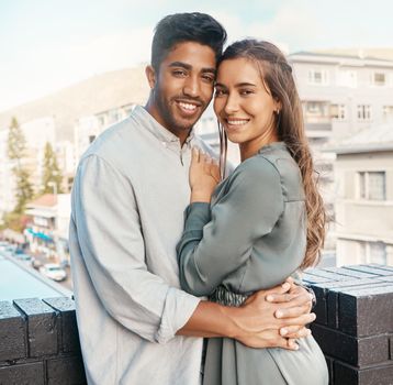 Love, couple and travel with a man and woman tourist hugging on a balcony in a foreign city together. Romance, dating and diversity with a young male and female on honeymoon overseas or abroad