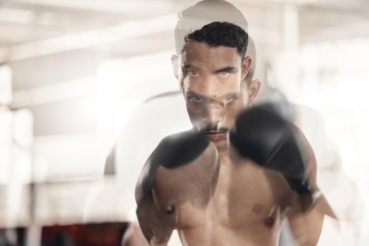 Boxing, sports and fitness with motion blur and a man boxer training in a gym for health and wellness with special effects. Workout, exercise and fight with a healthy and stong male fighter in gloves