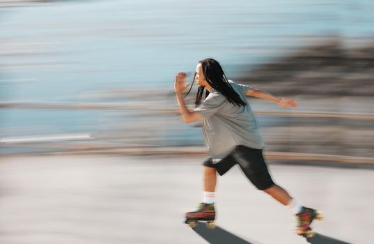 Fitness, exercise and a man on roller skates moving fast with blurred background. Action, movement and an adrenaline rush skating in road. Speed, sports and a dreadlocks skater having fun in the sun.