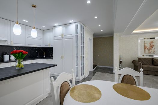 Luxurious white modern domestic kitchen with black marble worktop