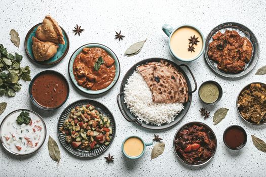 Indian ethnic food buffet on white concrete table from above