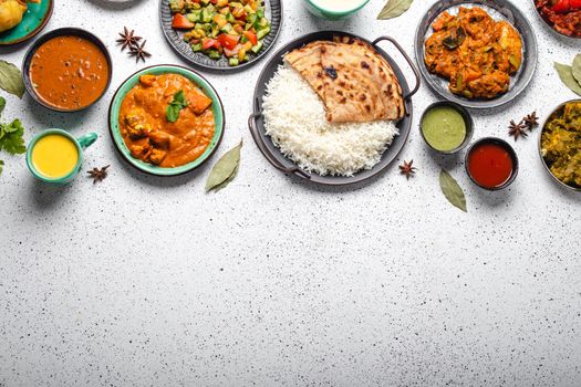 Indian ethnic food buffet on white concrete table top view copy space