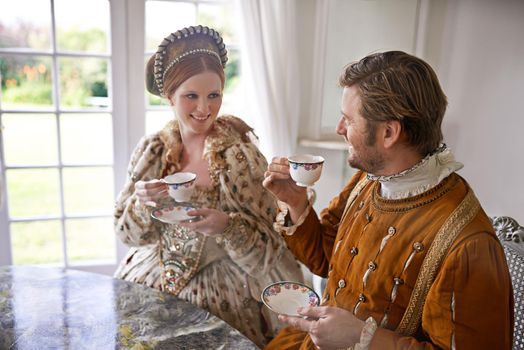 One simply never misses high tea. A king and queen taking tea together at home.