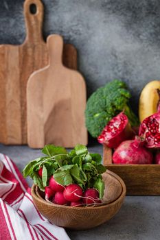 Radish bunch with fruit and veggies on kitchen table
