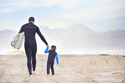 Headed for a surf with his son. Shjot of a father and son enjoying a day outdoors.