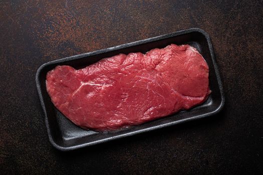 Beef lean raw fillet steak in black plastic container
