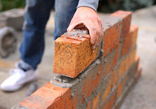 Safe as bricks and mortar. a master bricklayer at work.