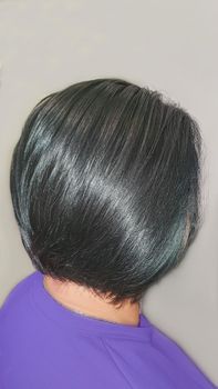 Haircut and styling in a beauty salon. Black hair.