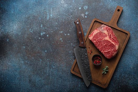 Raw meat beef marbled prime cut steak Ribeye on wooden cutting board
