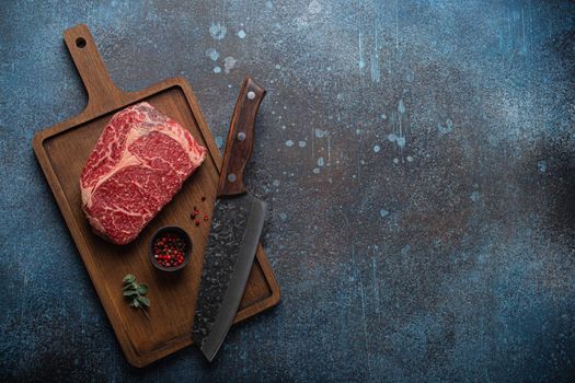 Raw meat beef marbled prime cut steak Ribeye on wooden cutting board