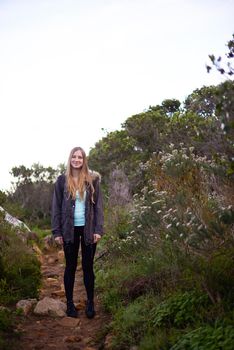 Hiking is her favorite hobby. Full length portrait of an attractive young female hiker in the outdoors.