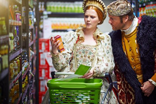 What manner of elixir is this my king. a king and queen looking at goods while shopping in a modern grocery store.