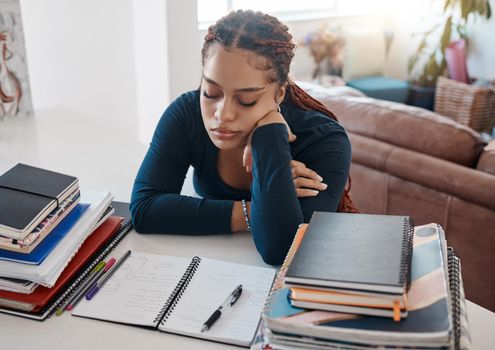 Sleep, books and black woman student writing homework in notebook or studying for exam test paper. College, University African or homeschool girl tired from learning, knowledge and education at house