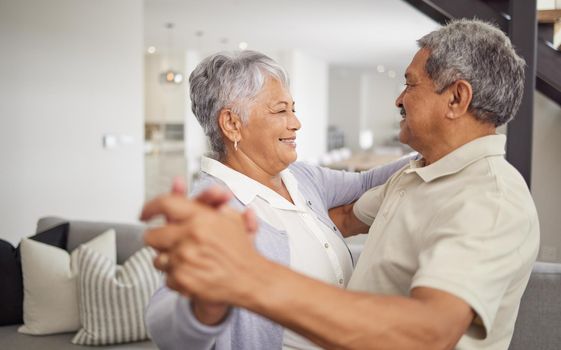 Love, dancing and happiness with a senior couple being playful and romantic while celebrating their anniversary or retirement at home. Happy man and woman bonding together in a healthy relationship