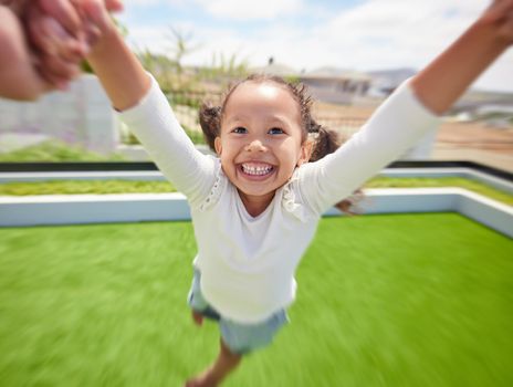 Girl child happy, parent pov of fun outdoor in garden and parent hand swinging kid by arms in circle movement. Family play game on green grass landscape park, young happiness and kids funny smile