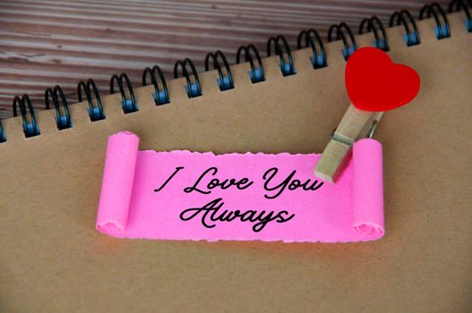 I love you text on torn pink paper. Romance and relationship concept
