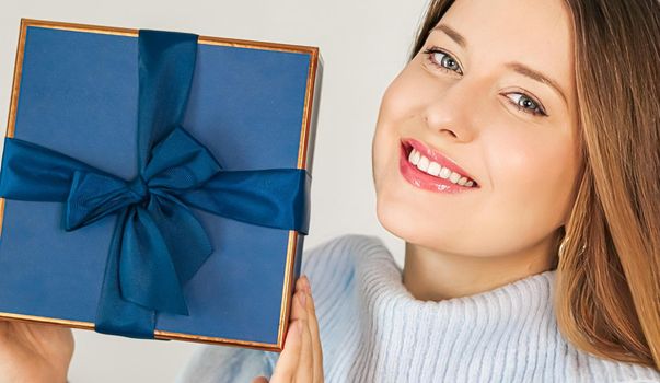 Winter holidays, present and Merry Christmas concept, happy woman smiling and holding wrapped gift box