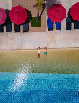 Aerial view from above at pool, tropical swimming pool from above with drone