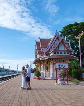 Hua Hin train station in Thailand on a bright day, men and women walking at train station Huahin