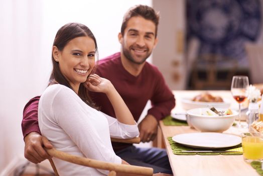Food brings everyone together. A happy couple enjoying a family meal around the table.