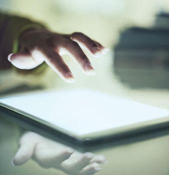 Intuitive technology. Cropped closeup of a womans hand above a digital tablet.