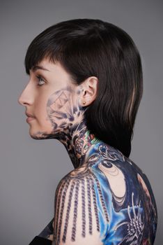 Wear your art on your sleeve. A cropped studio shot of a beautiful young tattooed woman.