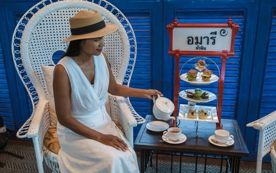 Asian women having a Luxury high tea with snack and tea in a luxury hotel