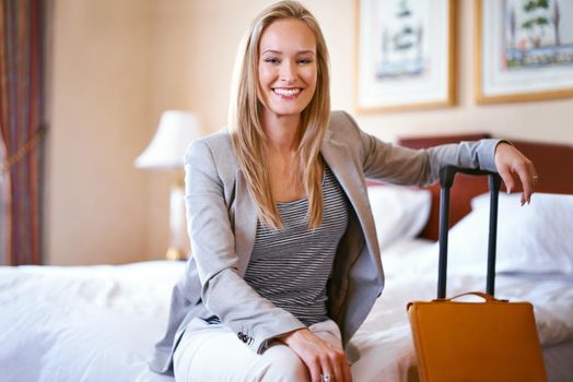 This is my hotel of choice. Portrait of a beautiful businesswoman in her hotel room.