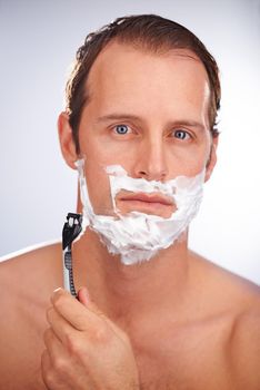 That was a close shave. a man shaving isolated on white.