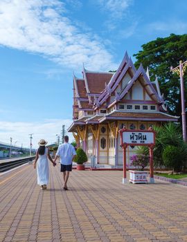Hua Hin train station in Thailand on a bright day, men and women walking at train station Huahin