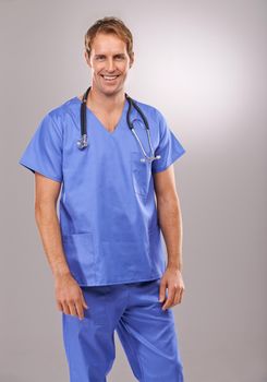 He has superb surgery skills. Studio portrait of a handsome doctor standing against a gray background.
