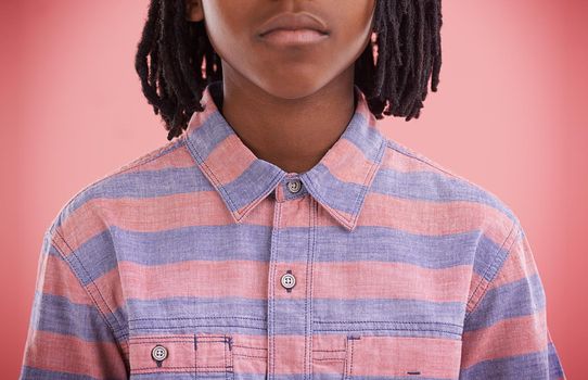 Stripy style. Cropped studio shot of a young boy wearing a striped shirt.